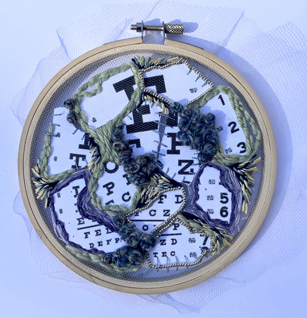 embroidered collage consisting of ripped eye charts (shoutout) and recycled yarn