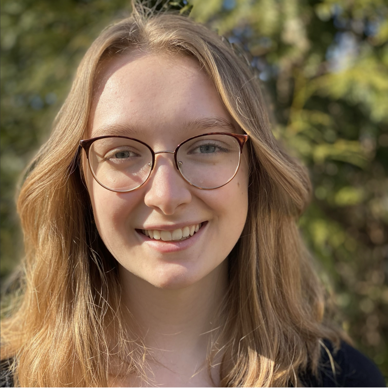 a headshot of me, a blonde woman with shoulderl-length hair and glasses
